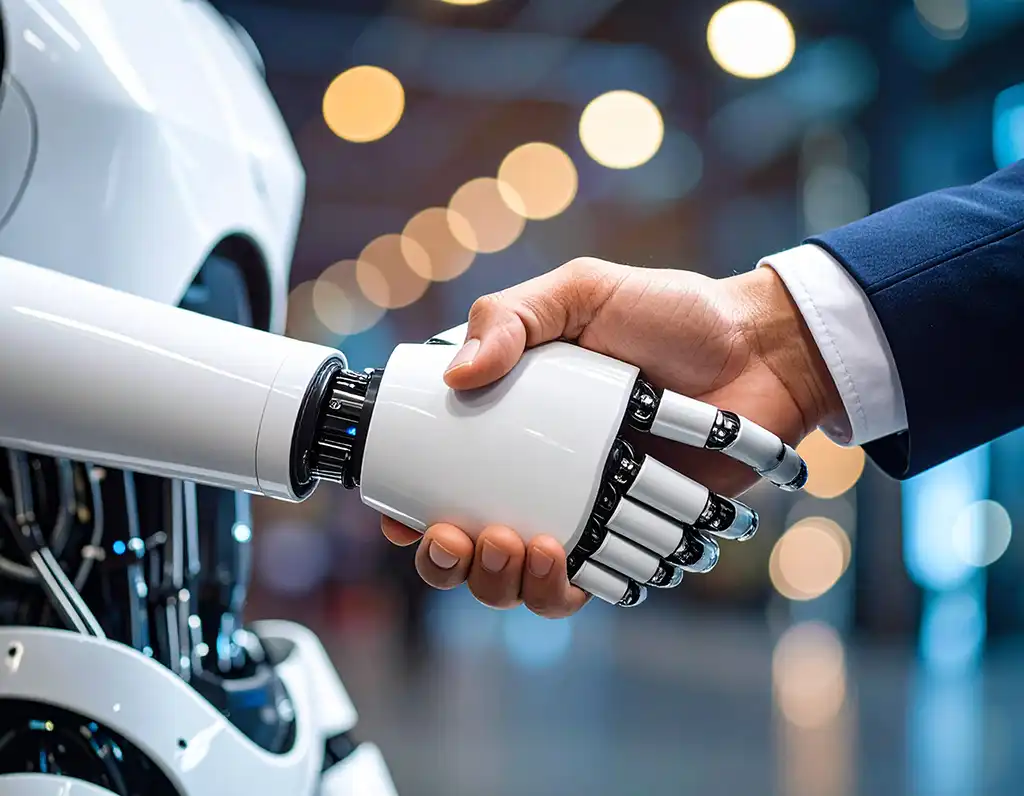 Stretta di mano tra un umano e un robot in contesto aziendale, simbolo di collaborazione tra intelligenza artificiale e lavoro umano