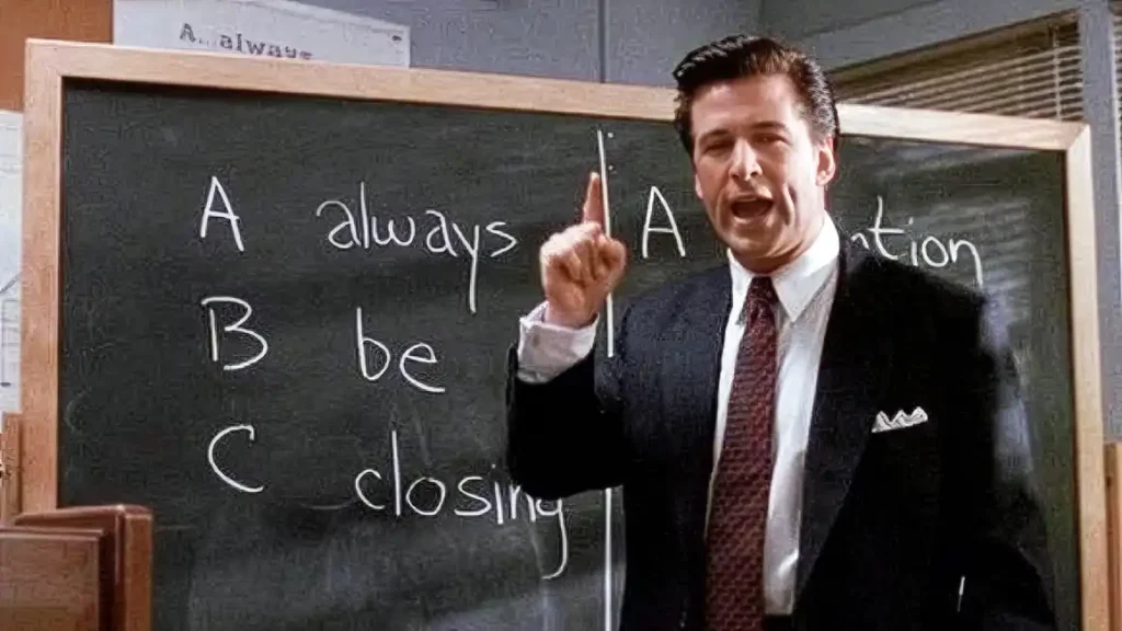 Scena del film Americani (Glengarry Glen Ross) con venditore davanti a lavagna Always Be Closing simbolo della pressione e di certe strategia di vendita telecomunicazioni